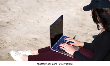 Summer,sea Beach. Sunrise, Beautiful Woman In A Black Cap, Blaser Is Working On Laptop. High Quality Photo