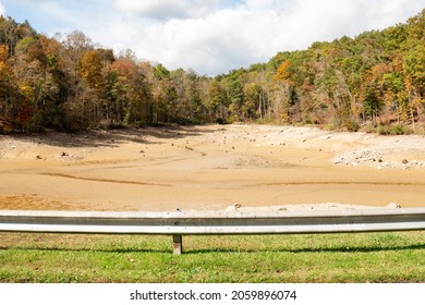 Summersville,, West Virginia US - October 13, 2021: Roadside View  Of Low Water Levels. In Reservoir Exposing Muddy Bottom Of Dried River And  Overflow Lake Bed Reduced To A Trickle Stream Of Fresh W