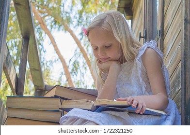 Summertime Fun. Cute Blond Girl Reading Book Outside