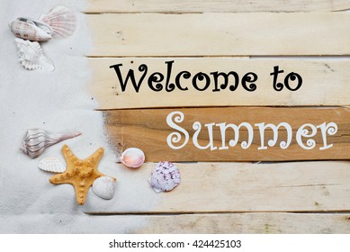 Summertime Image With Beach Theme Of Clean White Sand Scattered On Boardwalk Planks With Starfish And Seashells Making A Side Border. Summer Message Added. Plenty Of Texture. Horizontal Composition.