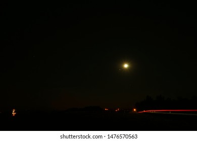 Summertime Night Rural Adventure From Middle Of Nowhere With Car Trails And The Moon Above