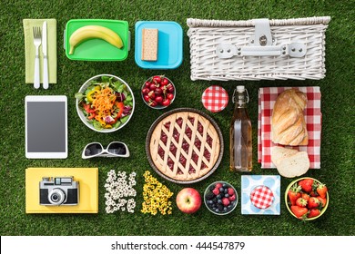 Summertime Picnic On The Grass With Basket, Salad, Fruit And Accessories, Flat Lay