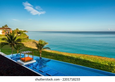 Summertime At A Tropical Resort With Blue Water, Infinity Pool, Gazebo And Vegetation  No People 