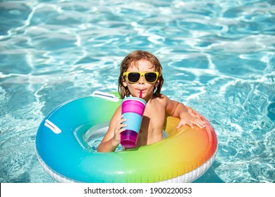 Summertime Vacation. Summer Child Weekend. Boy In Swiming Pool. Kid At Aquapark. Funny Boy On Inflatable Rubber Circle