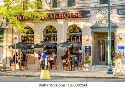 Summit, New Jersey USA - October 17, 2020: During The Pandemic, A Waiter And Diners Wearing Face Masks Can Be Seen At Outdoor Seating At The Roots Steakhouse.