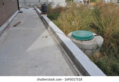 A Sump Pump, Septic Tank In The Back Yard Of The House. 