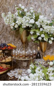 Sumptuous festive table laden with elegant chocolate cakes, sweet berry meringues, and a towering pyramid of vibrant fresh fruit