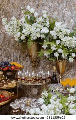 Sumptuous festive table laden with elegant chocolate cakes, sweet berry meringues, and a towering pyramid of vibrant fresh fruit