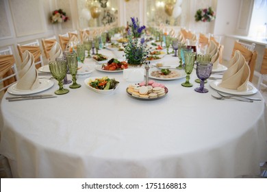 A Sumptuous Long Table With Food For Those Invited To The Feast. Serving And Design Of A Festive Dinner For A Banquet In A Restaurant.