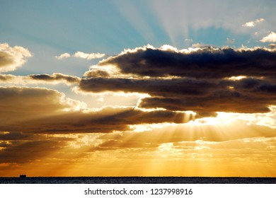 Sun beams break through the clouds over the sea