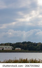 Sun Beams Through Clouds Over Shiny Big Lake