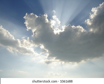 the sun behind the cloud