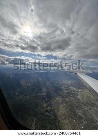 Sun behind clouds from airplane