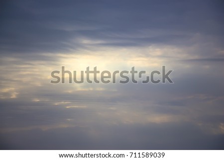 The sun behind the clouds breaking through the rays