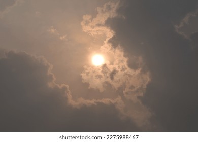 Sun behind the clouds at evening.