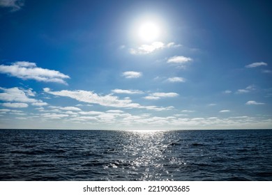 Sun Behind Clouds Over Pacific Ocean Blue Water And Blue Sky. Tourism Background Copy Space