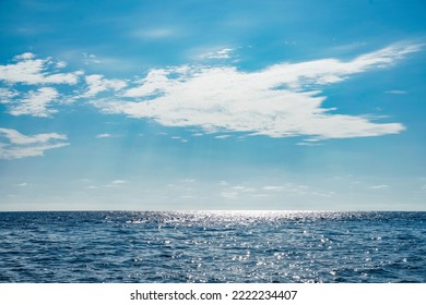 Sun Behind Clouds Over Pacific Ocean Blue Water And Blue Sky. Tourism Background Copy Space