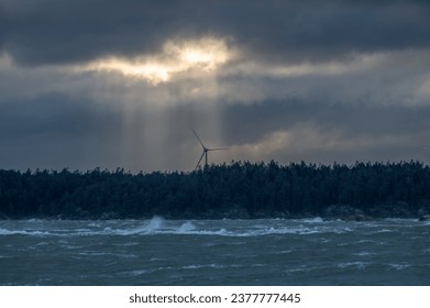 Sun behind clouds and wind blowing over water