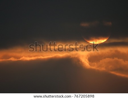 Similar – Image, Stock Photo Evening sun hidden behind clouds. Golden glow over the water.