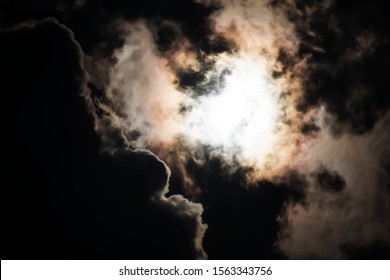 Sun Behind Dark Clouds In The Sky