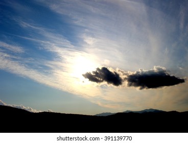 Sun behind high clouds