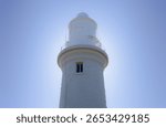 The sun behind a lighthouse 
