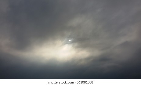 sun behind storm clouds