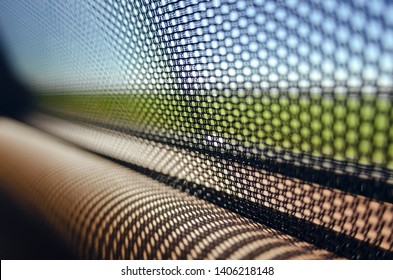 Sun blinds on the glass of the rear door of the car black color close-up protects the textured grid from the sun's rays. Car service
