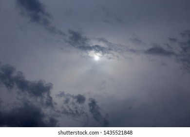 Sun in blue clouds background