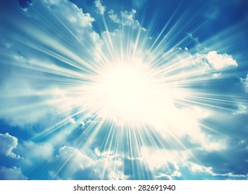Sun in the blue sky with clouds. Brightly sunlight. Sunny day. Freedom solar concept