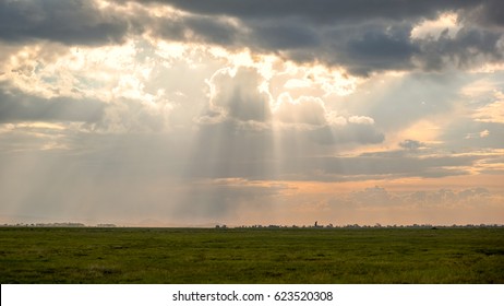 Sun breaking through the clouds in Amboseli National Park in Kenya