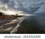 The sun is breaking through clouds at the beach of the Baltic Sea in Lubmin.