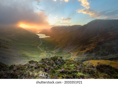 Sun Breaking Through Clouds Onto Mountain Landscape In The Lake District With View Of Buttermere And Fleetwith Pike. Cumbria, UK.