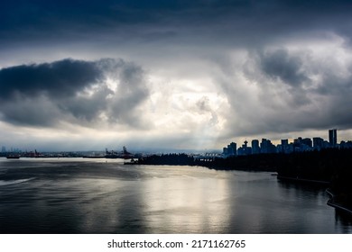 Sun Breaking Through Dark Clouds In Dramatic High Contrast Over Vancouver, British Columbia, Canada.