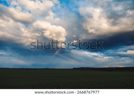 The sun breaks through the clouds after a thunderstorm on a summer evening. Textured and dynamic sky. Dramatic and strange sky during bad weather. Photo wallpaper. Beauty of earth.