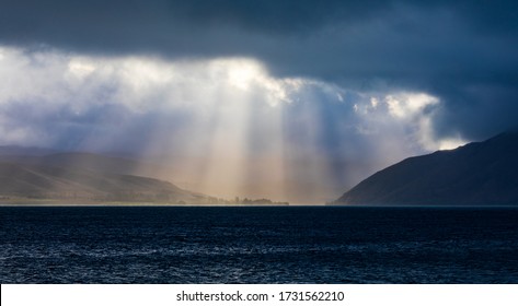 The Sun Breaks Through The Clouds Over Lake Aviemore, New Zealand