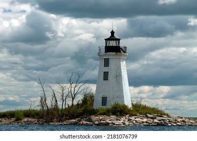 Sun breaks through storm clouds at old tower of Black Rock Harbor lighthouse, also known as Fayerweather Island light, in Bridgeport, Connecticut.