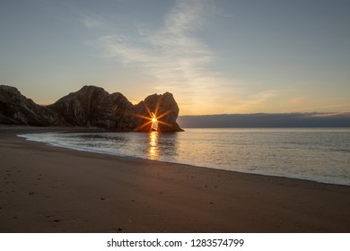 Sun Burst Sunrise Through The Arch At Durdle Door, Dorset