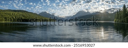Sun Burst Through Clouds Over Bowman Lake in Glacier National Park