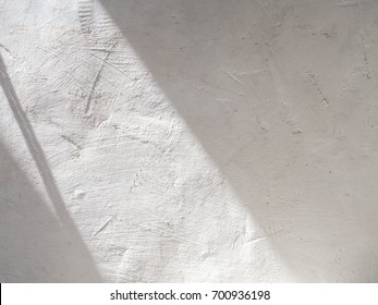 The sun is casting over the white concrete wall,sunshade shadow