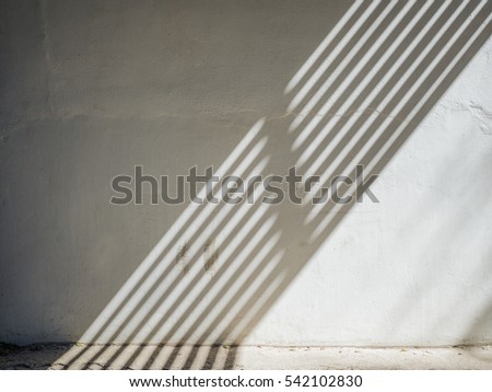 The sun is casting over the white concrete wall,sunshade shadow