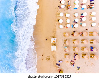 Sun Chairs And Umbrellas Bird's Eye View On Sand Beach In Greece