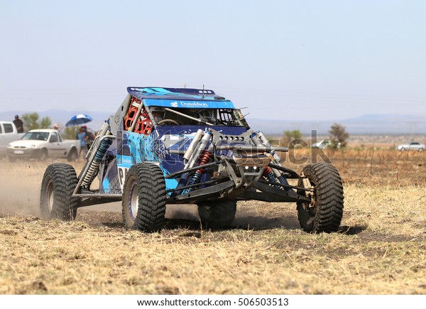 Sun City,\
South Africa - OCTOBER 1, 2016: Forty Five degree close-up view of\
Speeding Blue Bat Spec 0 rally car in race at Sun City 450 Rally\
Racing event, Sun City, South Africa \
