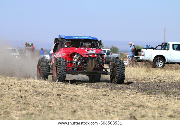 Sun City, South Africa - OCTOBER 1,\
2016: Front view of Speeding red Porter  rally car in race at Sun\
City 450 Rally Racing event, Sun City, South Africa \
