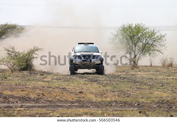Sun City,\
South Africa â?? OCTOBER 1, 2016: Front view of black and white\
Nissan Navara rally car racing through bush at Sun City 450 Rally\
Racing event, Sun City, South Africa \
