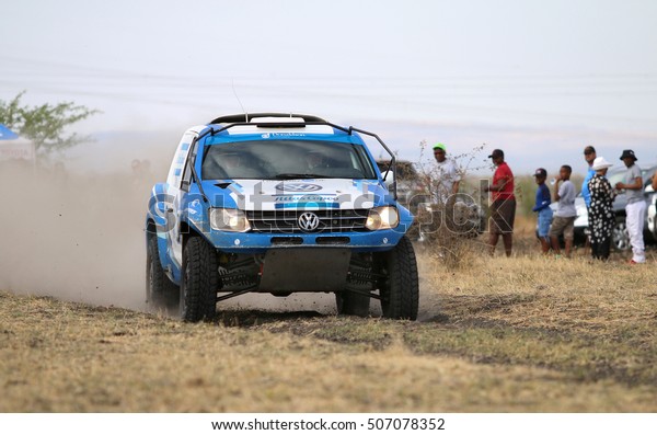 Sun City,\
South Africa - OCTOBER 1, 2016: Front view of Speeding blue and\
white VW Amarok twin cab rally car in race at Sun City 450 Rally\
Racing event, Sun City, South Africa \
