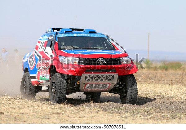 Sun City, South Africa - OCTOBER 1, 2016: Forty Five\
degree close-up view of Speeding red and blue Toyota Hilux twin cab\
rally car in race at Sun City 450 Rally Racing event, Sun City,\
South Africa  