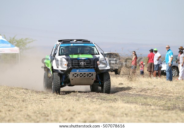 Sun City,\
South Africa - OCTOBER 1, 2016: Front view of Speeding green and\
white Toyota Hilux twin cab rally car in race at Sun City 450 Rally\
Racing event, Sun City, South Africa \

