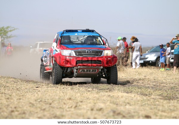 Sun City,\
South Africa - OCTOBER 1, 2016: Front view of Speeding red and blue\
Toyota Hilux single cab rally car in race at Sun City 450 Rally\
Racing event, Sun City, South Africa \
