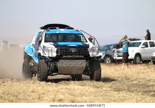 Sun\
City, South Africa Ã¢?? OCTOBER 1, 2016: Front view of Speeding\
white and blue Toyota Hilux twin cab rally car in race at Sun City\
450 Rally Racing event, Sun City, South Africa \
